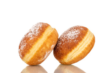 Two sweet donuts stuffed with jam, macro, isolated on a white background.