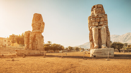 Famous two Colossi of Memnon - massive ruined statues of the Pharaoh Amenhotep III. Travel and...
