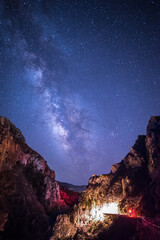 Beautiful Milky Way galaxy as seen between rocky mountains in Crete, Greece