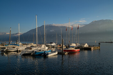 Winter landscape of lake Maggiore with boats in Locarno, Switzerland