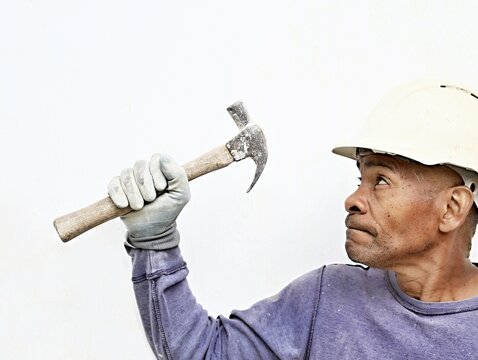 professional builder holding his tools on white background stock photo