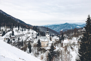 Beautiful shot of a church in Spania Dolina, Slovakia in winter - obrazy, fototapety, plakaty