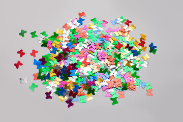 butterfly shaped confetti isolated on gray surface