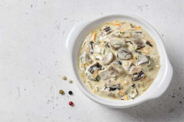 Creamy garlic carrot mushroom pasta sauce in pot. Top view, copy space.