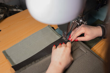 Ukrainian girl sews bulletproof vest for a warrior