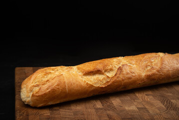 Fresh baguette on black background