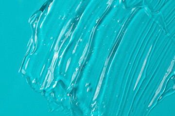 Background from turquoise textured cosmetic gel.Top view,antibacterial liquid surface.Good as...