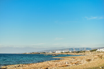 white houses on the mediterranean sea island of cyprus, houses on the rocks, blue sky, sea shore