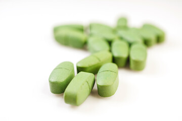 Green pain pills isolated on a white
