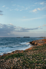 Rocky coastal landscape scene at shore of ocean. High quality photo