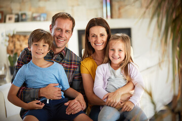 Love and care is what nurtures a family. Portrait of a happy family relaxing together at home.