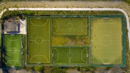 Orthogonal aerial view on a sports center with many soccer and five-a-side football fields.
