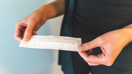 woman holds unopened sars covid 19 nasal test swab in hands