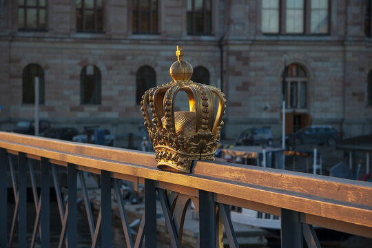 Gold Crown On A Bridge Grille In Stockholm On A Sunset Light, Side View