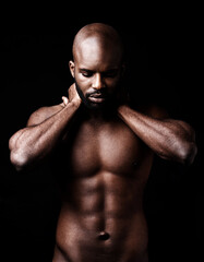 Fototapeta na wymiar Six pack perfection. Studio shot of a muscular man closing his eyes while holding his neck.