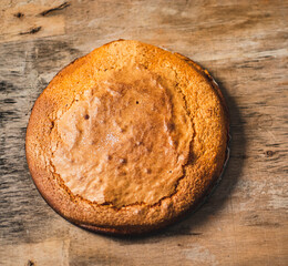 Homemade yogurt sponge cake on a wooden base