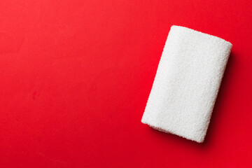 Top view of white towels with copy space on colored background