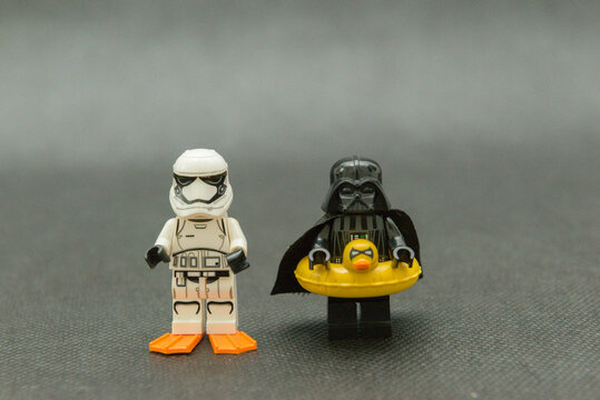 Minifigure of Darth Vader and stormtrooper on vacation wearing a duck float and fins