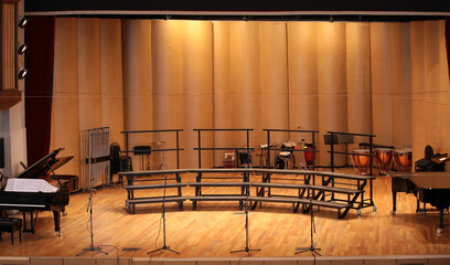 View of an empty large concert stage with a microphone piano a place for the choir