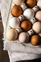 multi-colored domestic eggs photo in rustic style