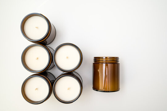 Product photo of candles in amber colored jars