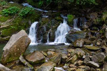 Two small mountain waterfalls in forest