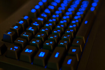 Gaming Keyboard with Illuminated Keys. black keys with blue glowing letters