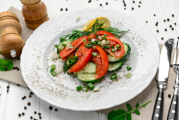 Cucumber, tomato and green onion salad with olive oil