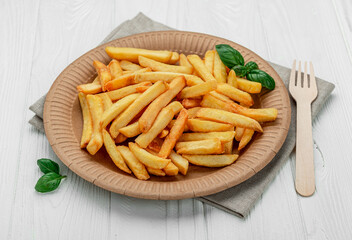 French fries. Fried potatoes on a paper plate.