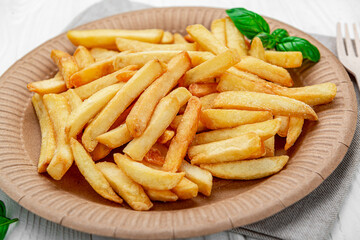 French fries. Fried potatoes on a paper plate.