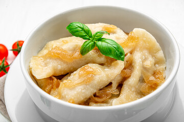 Boiled dumplings on a white plate close-up. Vareniki.