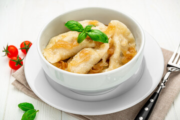Boiled dumplings on a white plate close-up. Vareniki.