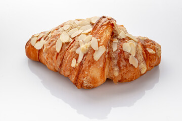 Fresh baked nutty breakfast croissants with nut flakes.