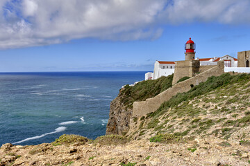 Fototapeta na wymiar Lighthouse and cliffs at Cape Saint Vincent in Algarve, near Sagres, Portugal