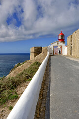 Lighthouse and cliffs at Cape Saint Vincent in Algarve, near Sagres, Portugal