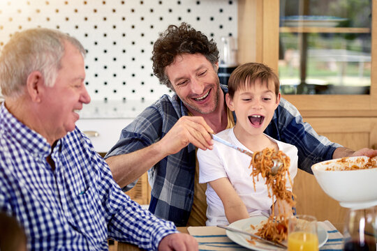 Are You Sure Youre Going To Eat All That, Dad. Shot Of A Multi Generational Family Enjoying A Meal Together At Home.