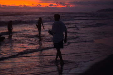 silhouette of a person walking on the beach