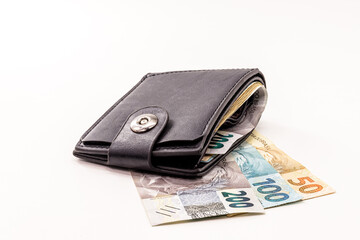 wallet full of money, money from Brazil, 200, 100 and 50 reais banknotes. Financial savings or...