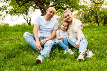 happy family resting in summer park on the grass. Family concept	