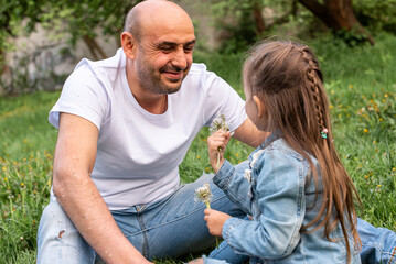 happy, emotional, father playing with daughter in nature. The concept of a happy family, comfort, family time. Selective focus