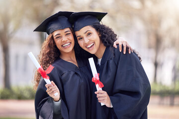 Welcome to the first day of your future. Shot of two young women hugging on graduation day.