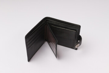 empty open black leather wallet on a button on a white background