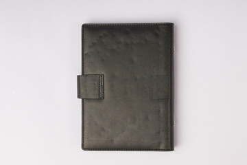 black leather diary in hardcover on the back on a white background