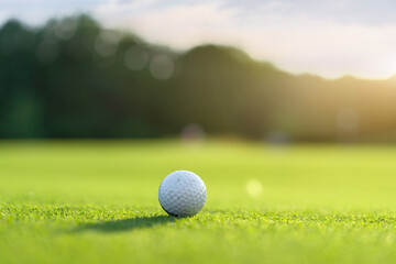 Golf ball on green field grass