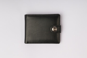 black leather wallet on a button on a white background, top view - obrazy, fototapety, plakaty