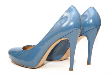 Blue sexy high-heeled shoes on a white carpet.