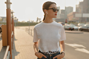 Close up portrait from back of stylish girl with dark hair and red lips is wearing dark sunglasses...