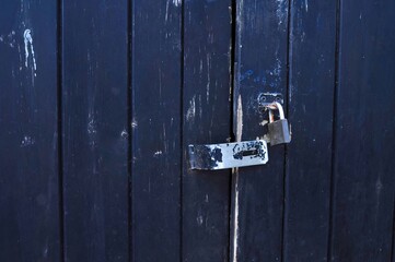 old blue wooden  door with lock 