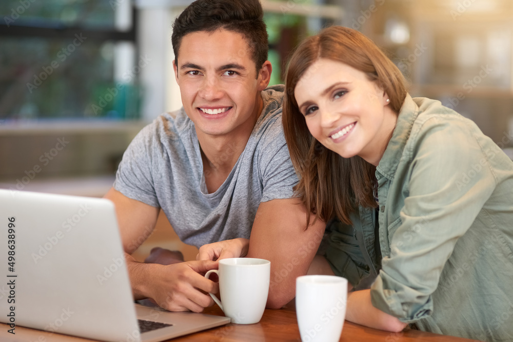 Canvas Prints Weekends are for wifi and being together. Portrait of a happy young couple using their laptop while having coffee in their kitchen at home.