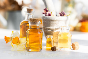 Assortment of organic essential oils. Natural moisturizing body and face treatment. Rose, camomile extract for healthy young skin. Relaxation, aromatherapy, salon spa. Close up, macro view